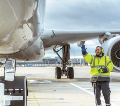 Menzies ground crew signaling aircraft